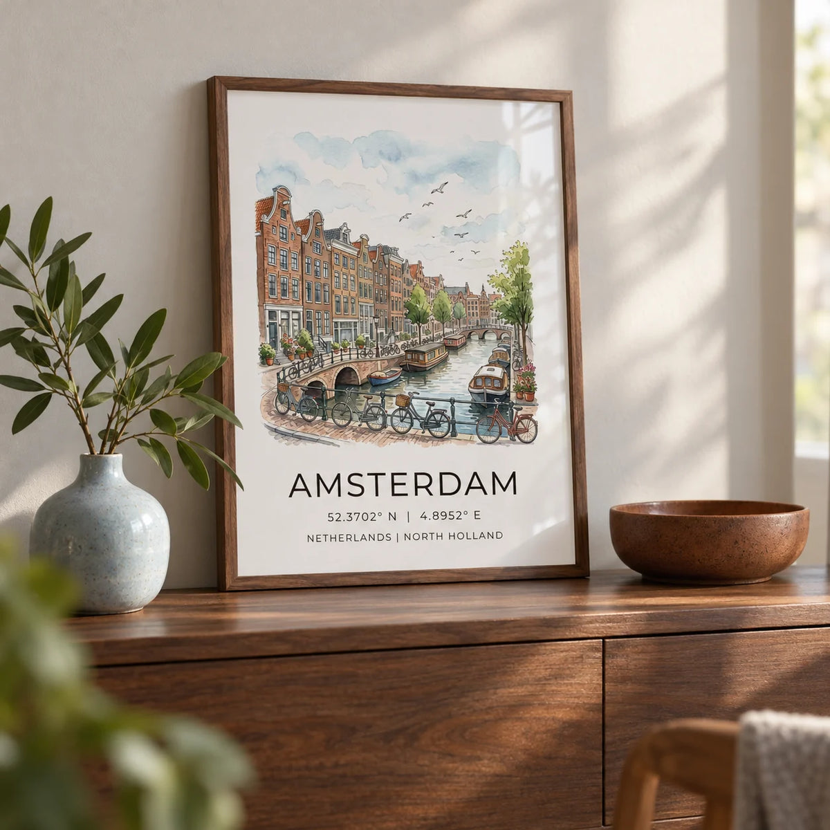 Amsterdam Canal Art Print, a small A4 framed print leaning on a walnut side table in a hallway