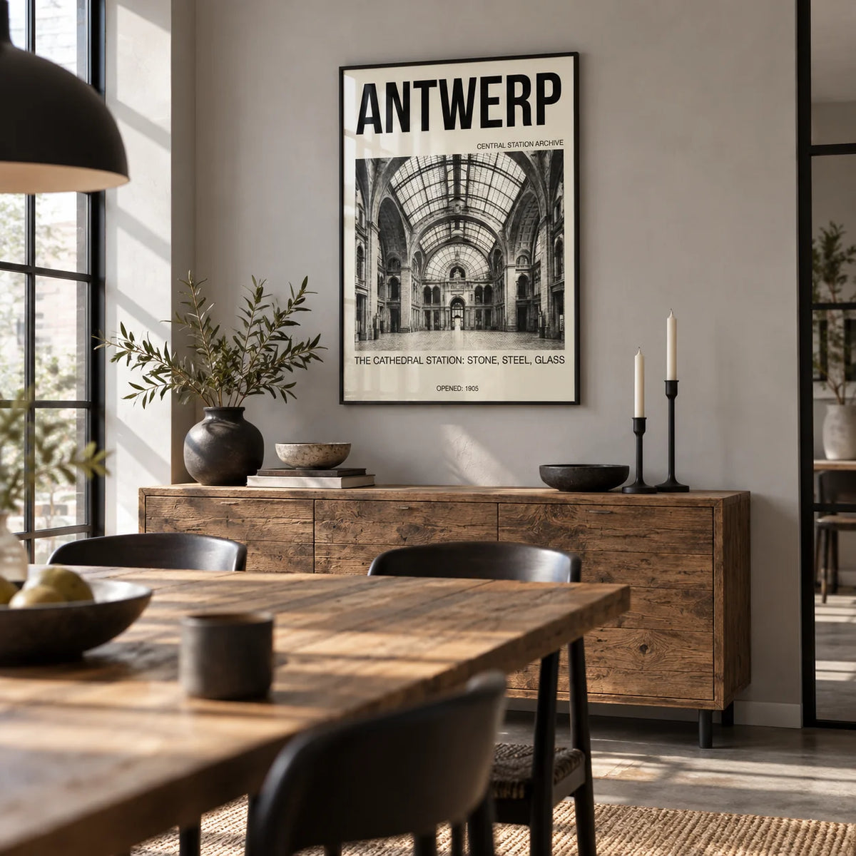 Antwerp Central Station Art Print, framed on the wall of a industrial-style dining room with a pale grey wall and black steel window frames