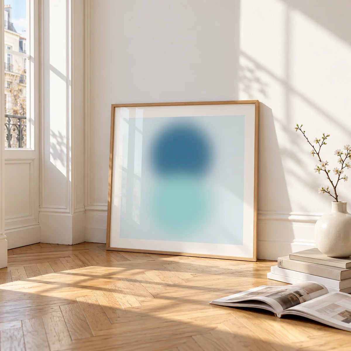 Aqua Print, framed and leaning on the parquet floor of a bright living room
