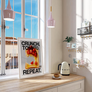 Print leaning on a kitchen table with photographic cherry tomatoes on toast and bold black text