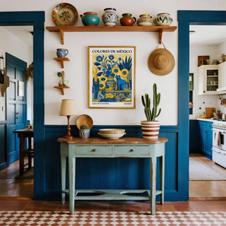Otomi wall art of a blue cat and yellow sunflowers above a blue sideboard in kitchen doorway