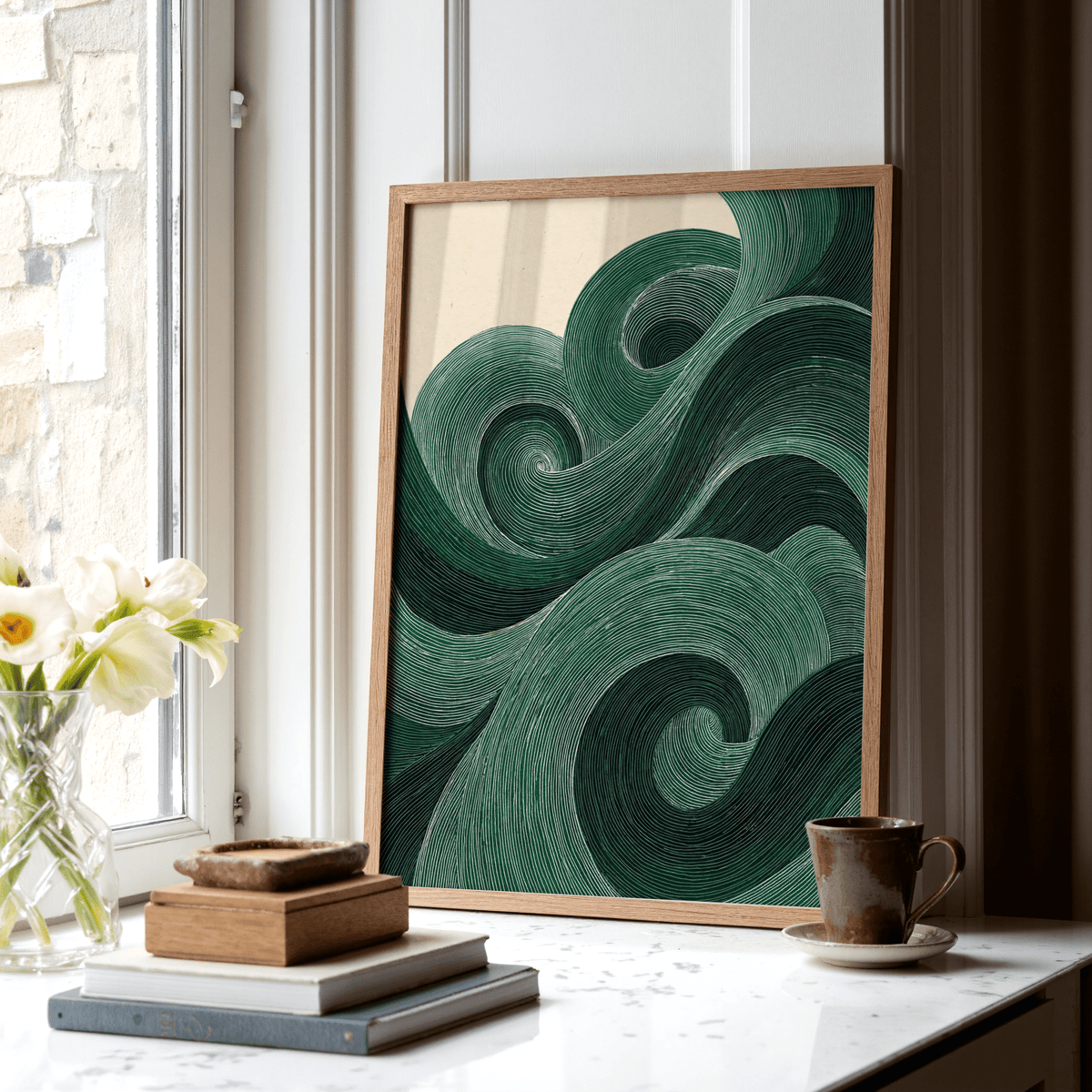 Modern Green Wall Art leaning on a windowsill with stacked books and a cup nearby