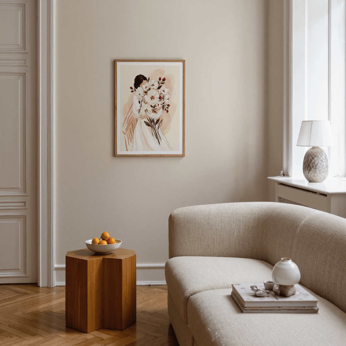 Woman Holding Flowers print with a woman holding white and red flowers above a wooden side table in a neutral living room