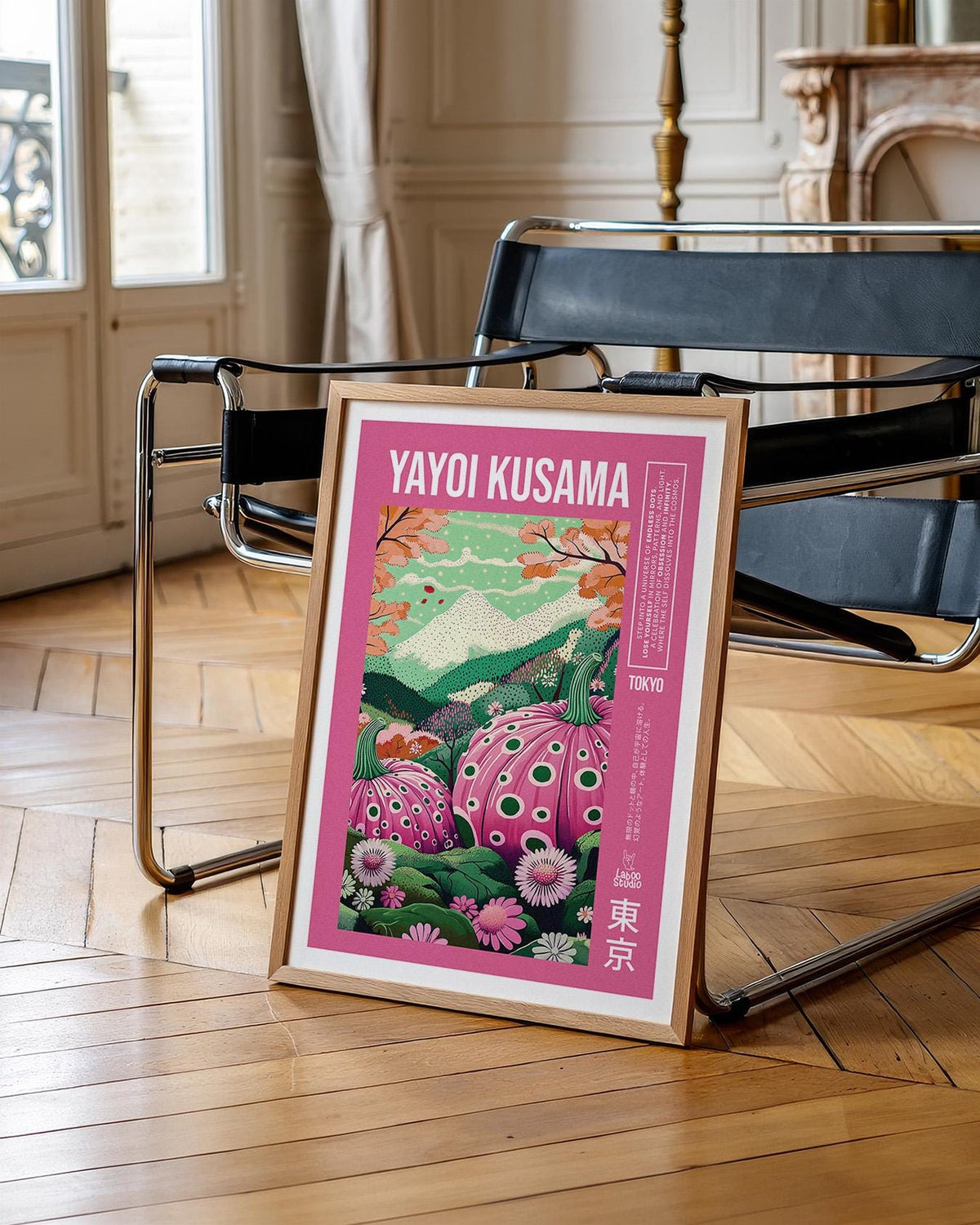 Wall Art with Pink polka dot pumpkins print leaning on wooden floor near a black chair