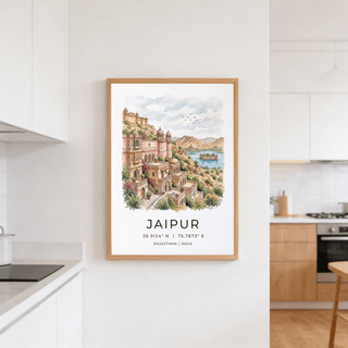 Jaipur Art Print on a white kitchen wall showing a pink and beige watercolour cityscape with blue sky