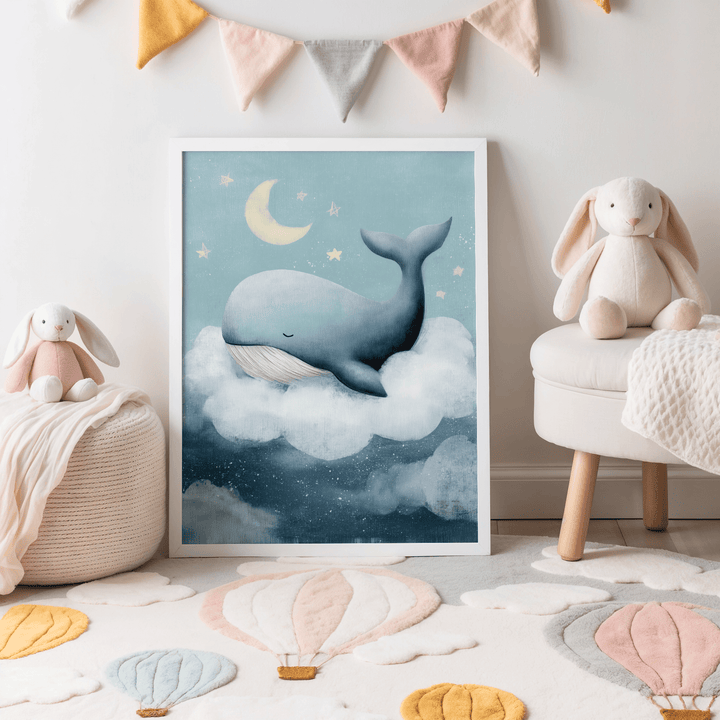 Print of dreamy whale nursery wall art on cloud in blue shades on floor near soft toys