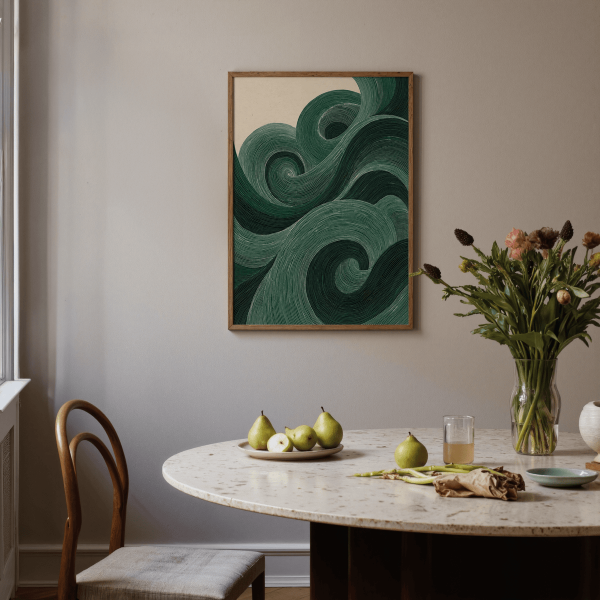 Modern green wall art with swirling line pattern above a dining table with pears and flowers