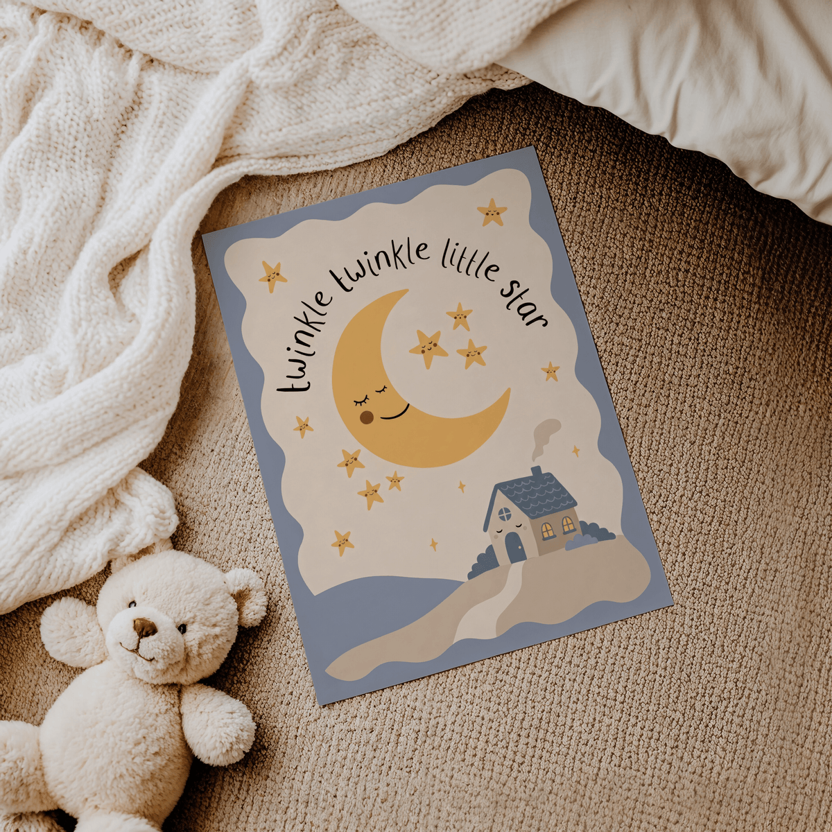 Twinkle Twinkle Star Print lying on a carpet next to a teddy bear and a knitted blanket