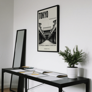 Nakamise Dori Art Print in black frame on a white wall above a black desk with papers and a potted plant