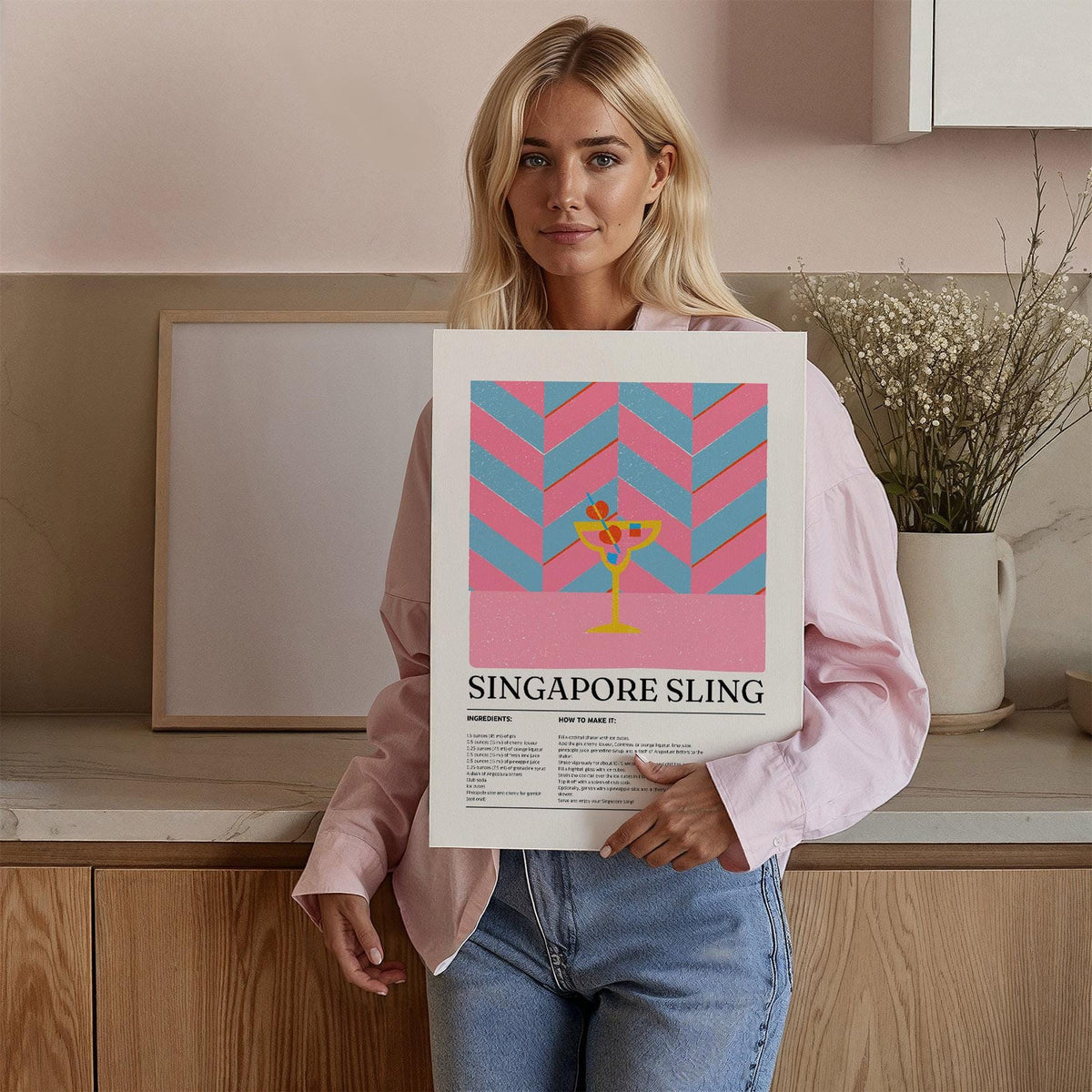 Drinks Art print held by woman featuring a Singapore Sling cocktail illustration in pink and blue chevrons