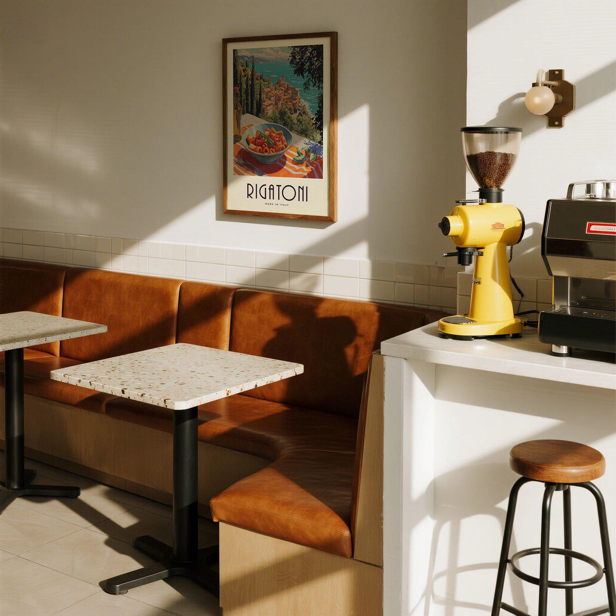 Pasta artwork print on a dining room wall above leather seating and sunlit tables