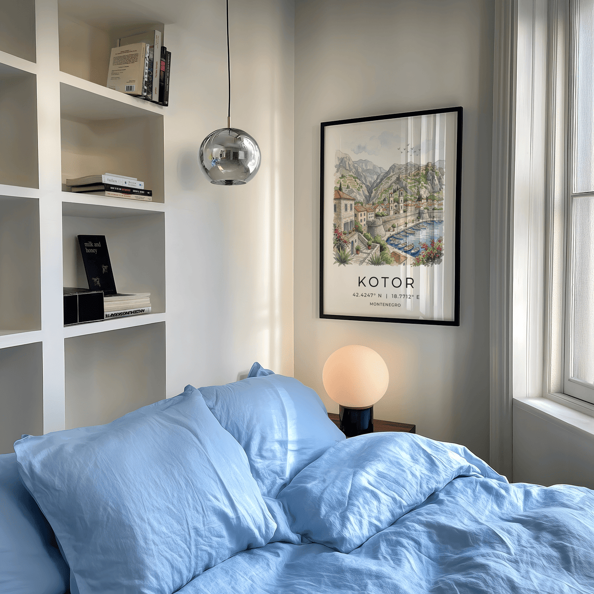 Kotor Landscape Art Print framed on a bedroom wall above a bedside table lamp with blue bedding