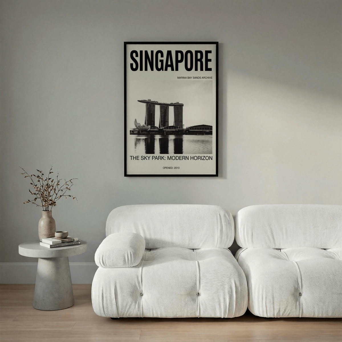 Singapore Modern Architecture Art Print above a white sofa with a grey wall and side table with a vase