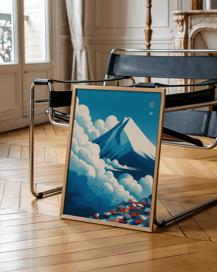 Japanese Cloud Poster leaning print of a snowy mountain and village with blue clouds beside a black chair