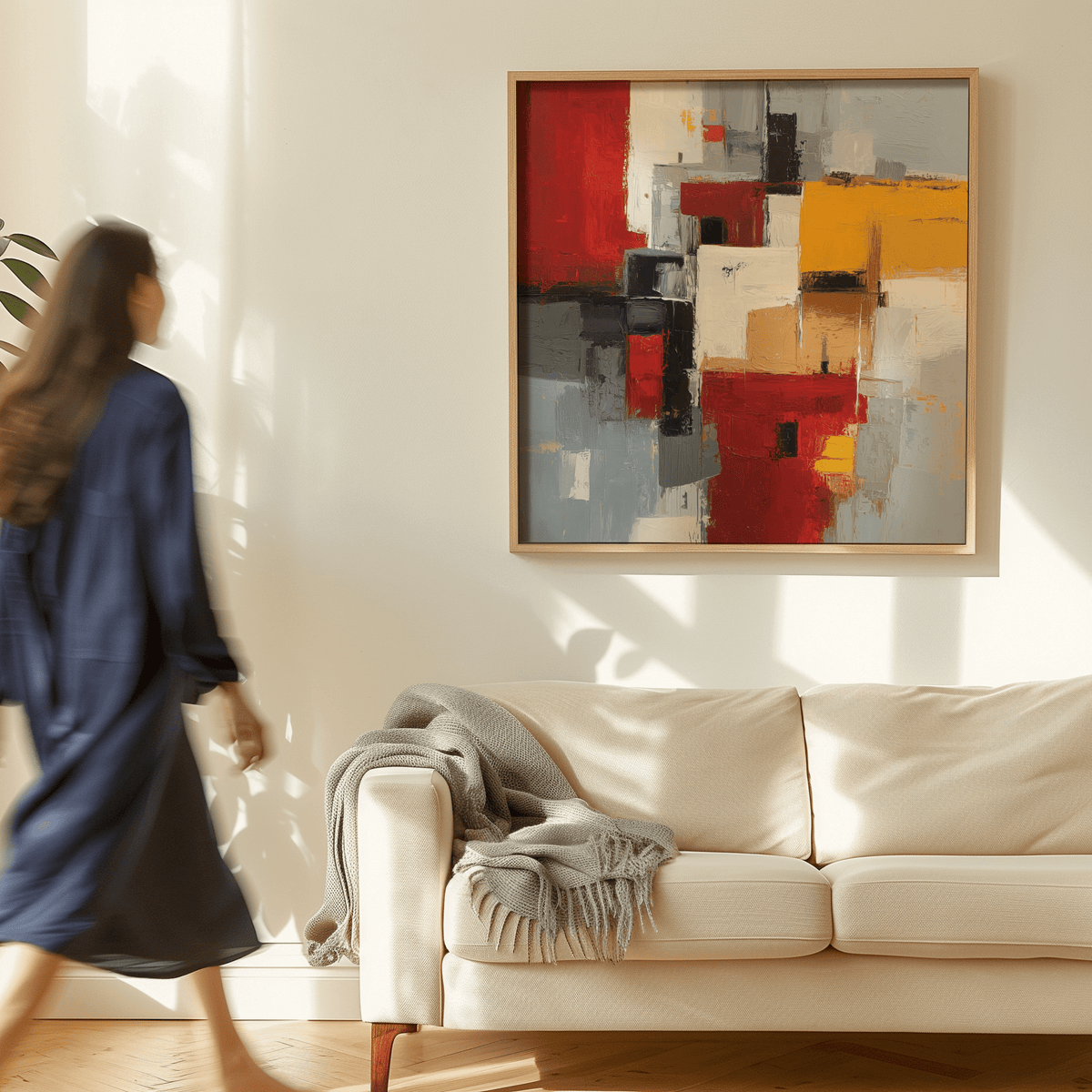 Colorful Abstract Poster Art hanging above a beige sofa with a grey throw in a sunlit room
