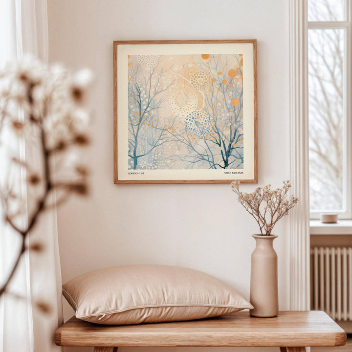 Minimalist Poster Art framed print of abstract branches with dots on a wall above a wooden table with a vase