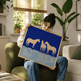 Framed Abstract Horse Poster with three cream spotted horses on a blue and pale background held by a woman