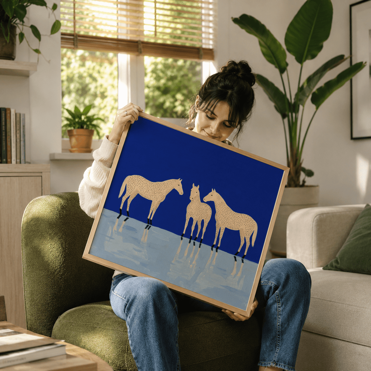 Framed Abstract Horse Poster with three cream spotted horses on a blue and pale background held by a woman