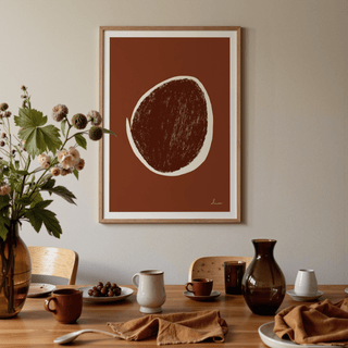 Abstract Earth Tone Art Print with brown and cream shapes above a wooden dining table with crockery and a glass vase
