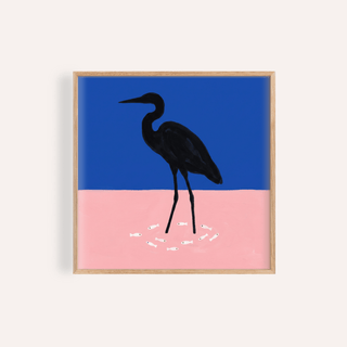 Framed heron art print with blue and pink background and small white fish
