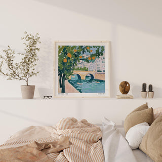 Wall Art of Paris on a shelf above a bed with cushions and striped bedding