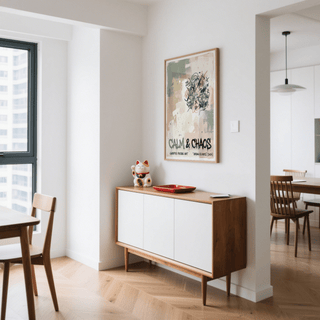 Urban graffiti art print with green and beige abstract background above a sideboard with a cat figurine in a dining room