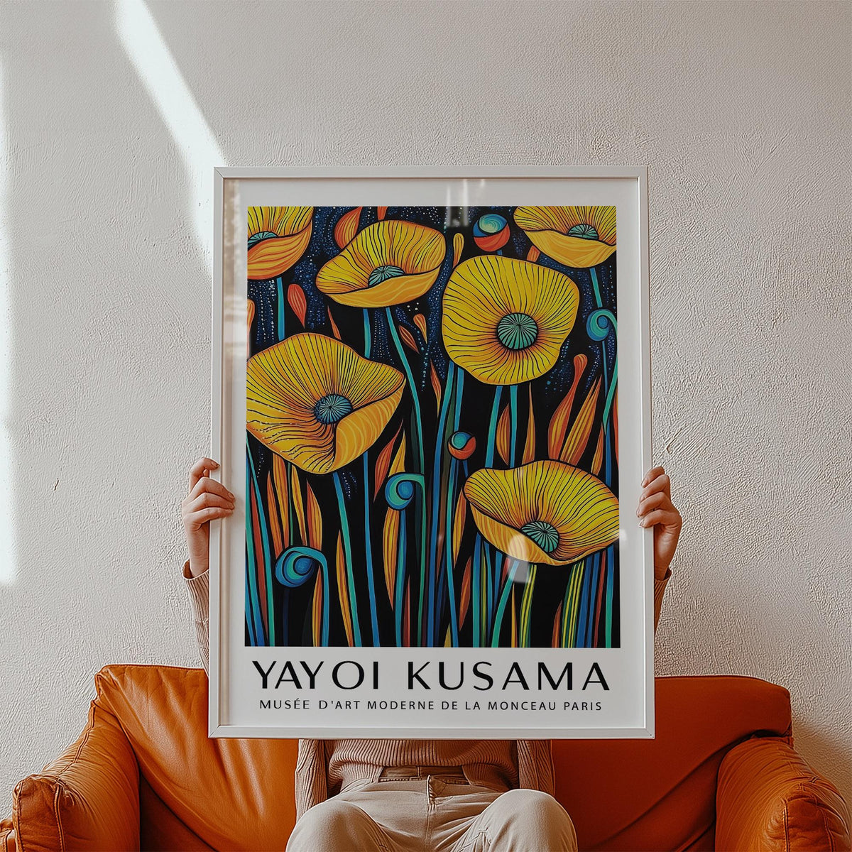 Framed Poppies wall art with yellow flowers and turquoise stems held above a brown leather sofa