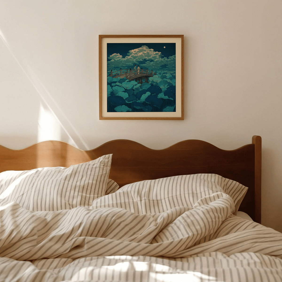 Hasui Kawase Japanese Woodblock Lotus wall art above a bed with striped bedding in a neutral bedroom