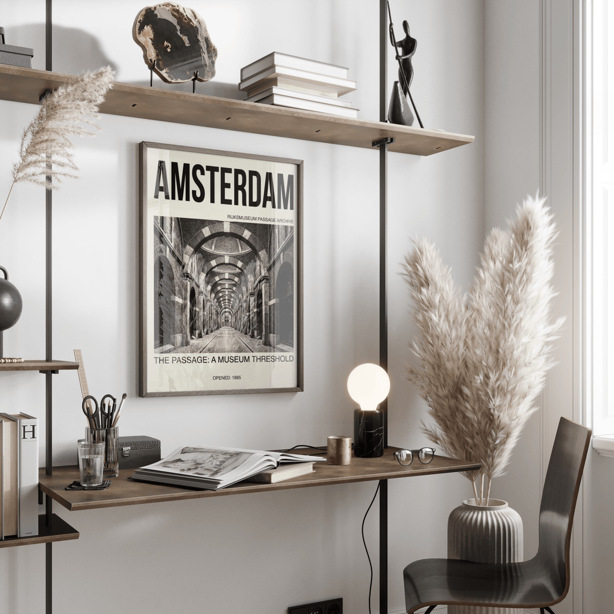 Amsterdam Passage wall art in black and white with bold text on a wall above a desk featuring a lamp and pampas grass