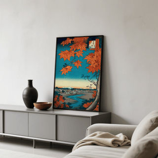 Print leaning on a grey sideboard with a black vase and bowl Japanese Landscape Art Print with red maple leaves and a blue sky