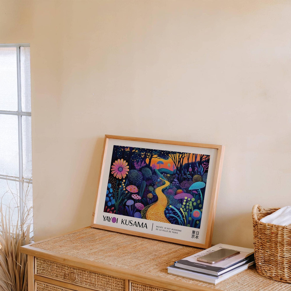 Print leaning on a sideboard of a glowing yellow path in a dark abstract forest with a purple flower and basket nearby