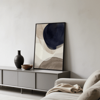 Abstract Watercolor Print leaning on a grey sideboard with a black vase and bowl in a living room
