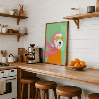 Funny Pet Poster print of a dog wearing yellow aviator goggles and a pink scarf in a kitchen on a wooden counter near a bowl of oranges