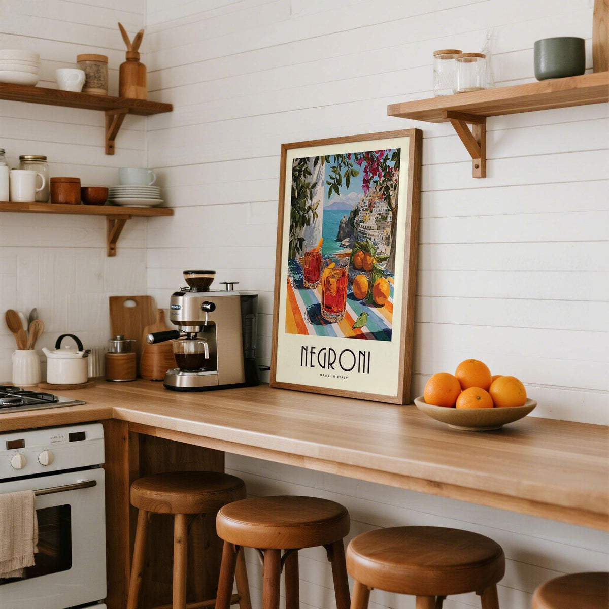 Print leaning on a kitchen counter with Negroni cocktails and oranges illustration and white tiled wall