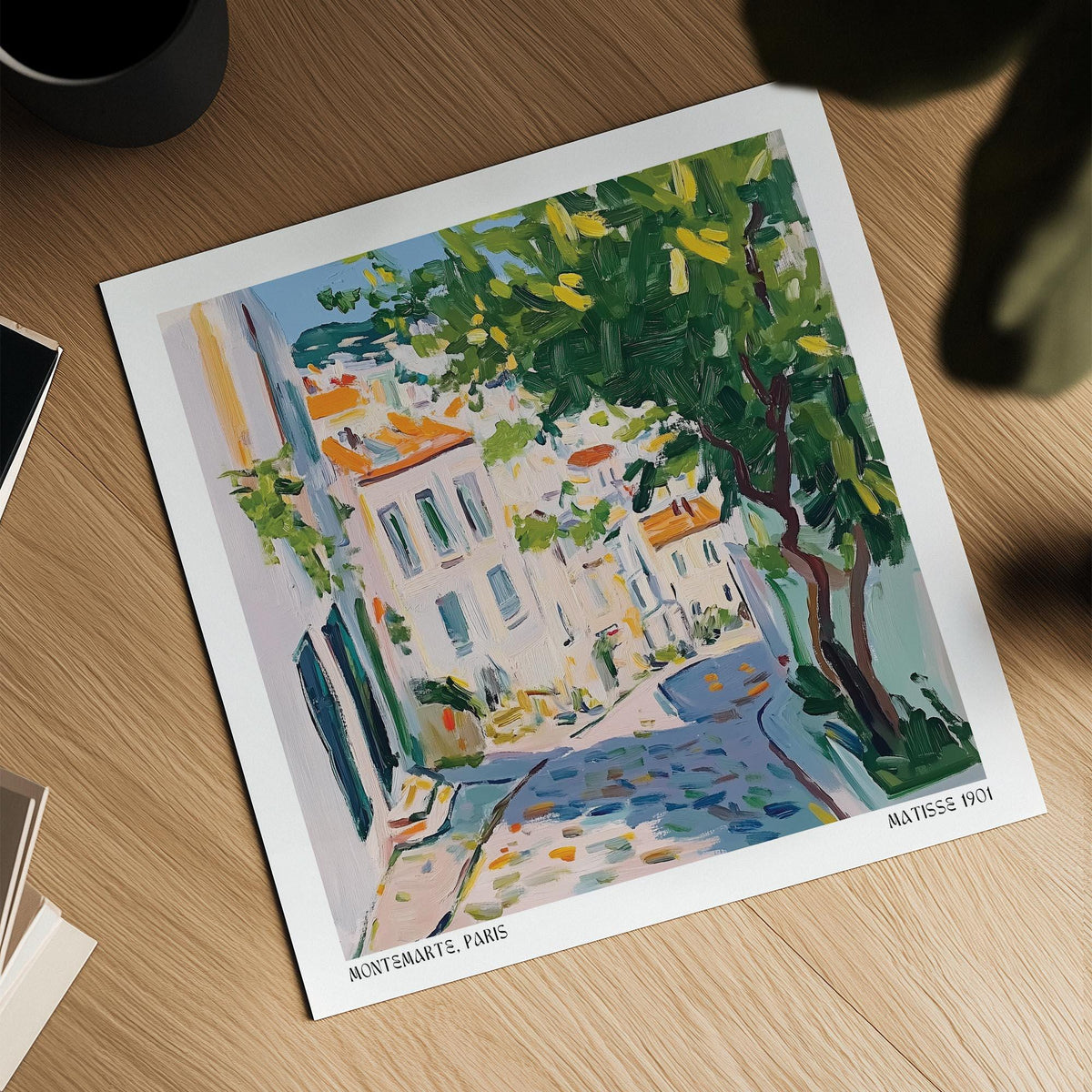French artwork prints laid flat showing a Paris street with green tree and muted colours