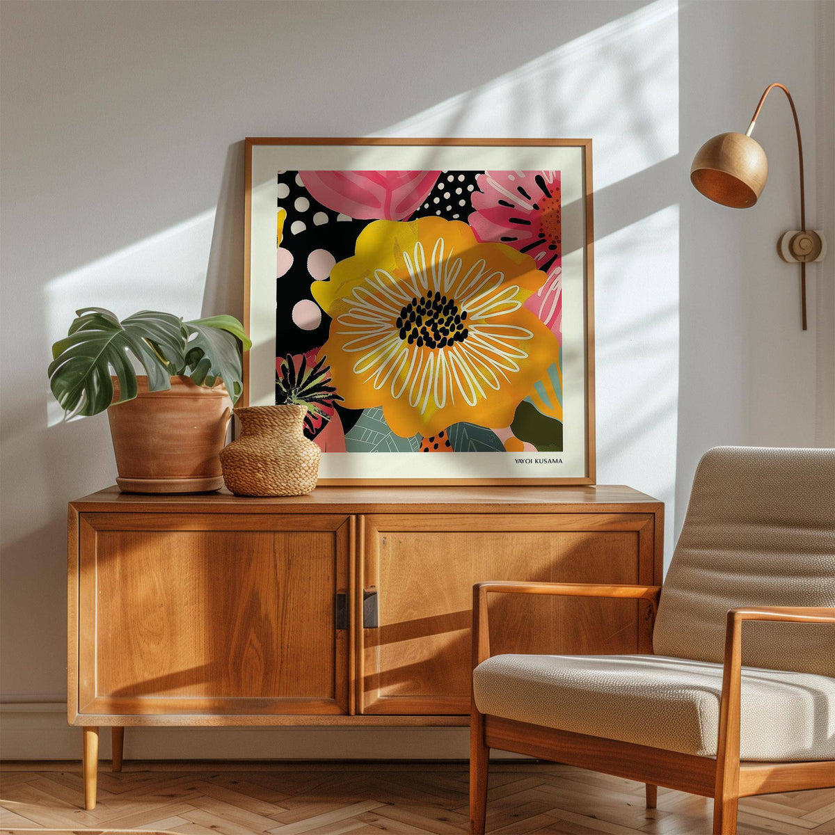 Flower posters print leaning on a wooden sideboard with a potted plant and wicker basket nearby