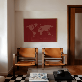 World Map Wall Poster hanging on a white wall above two brown leather chairs and a glass coffee table