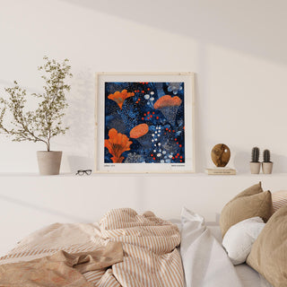 Blue Orange wall art of an abstract orange floral pattern in a light room above a low shelf with decor