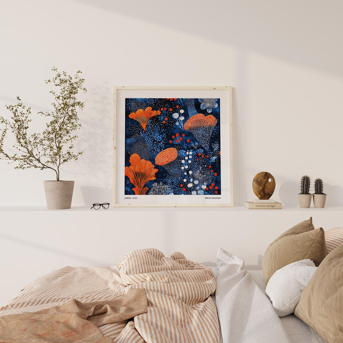 Blue Orange wall art of an abstract orange floral pattern in a light room above a low shelf with decor