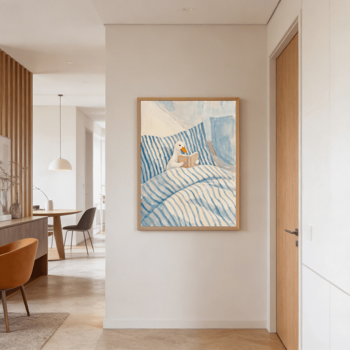 Duck Reading art print with a watercolour duck in blue striped bedding on a white wall in a hallway