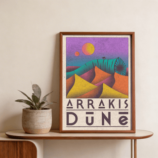 Framed Desert Dunes Sci Fi Poster with colourful dunes and worm on wooden shelf with potted plant