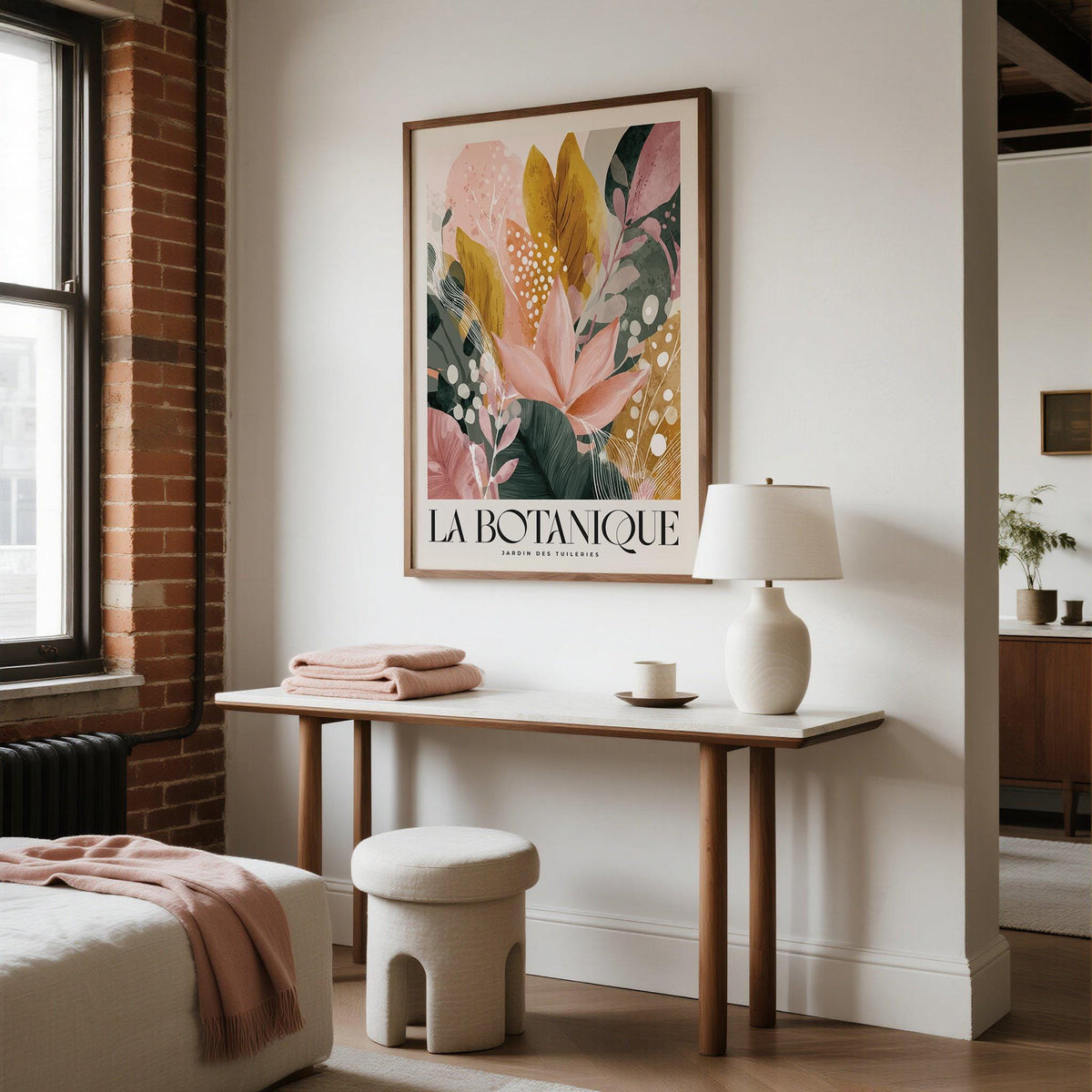 Flower prints framed print of abstract botanical leaves in muted pinks and gold above a console table with a lamp