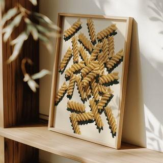 Fusilli Pasta Art framed print leaning on a wooden shelf with light and shadow details