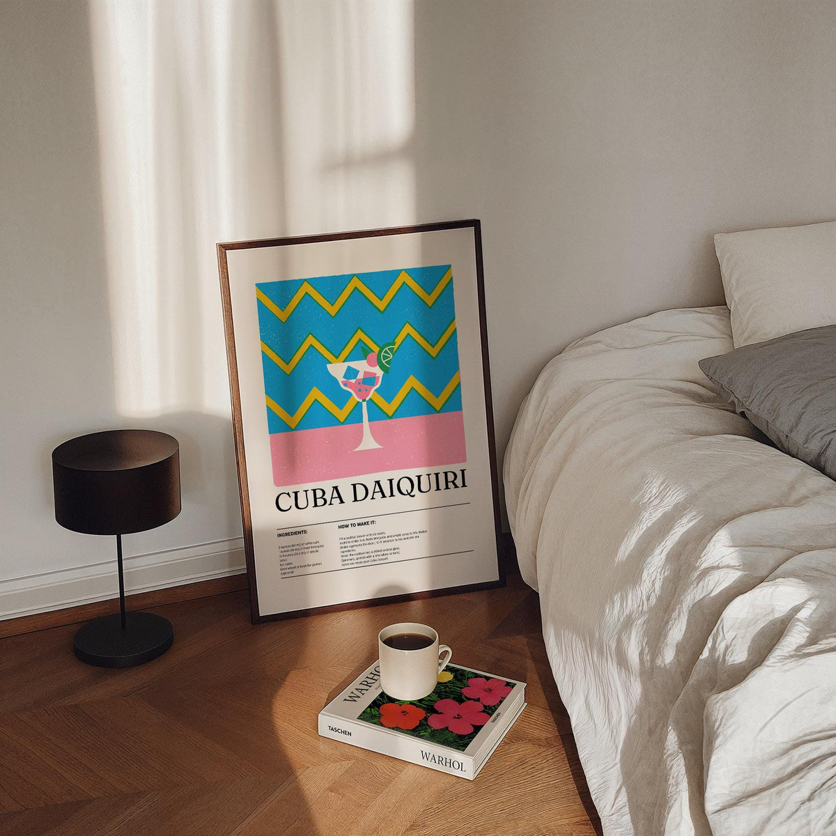 Print leaning on floor showing Alcohol Artwork with a colourful daiquiri cocktail next to a bed and lamp