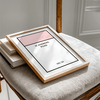 Framed print close-up of a minimalist street name sign design with pink and white blocks on a chair