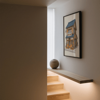 Japanese Coffee Poster print in thin black frame above shelf with round vase in hallway