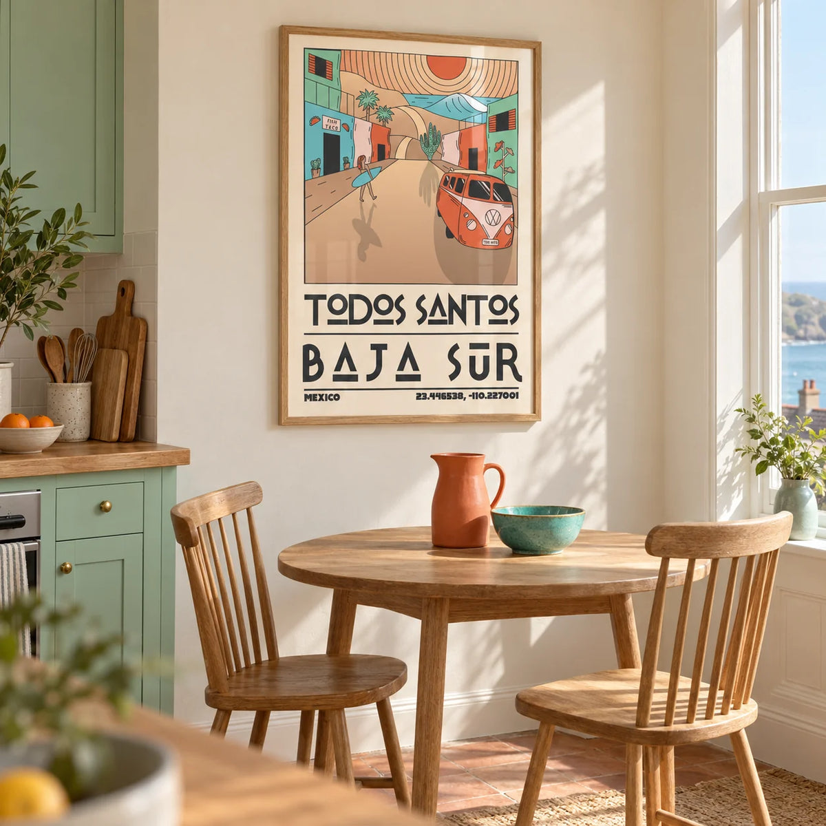 Baja Sur Art Print, framed on the wall of a bright kitchen breakfast corner in a UK seaside terrace with mint green cabinets and a warm cream wall