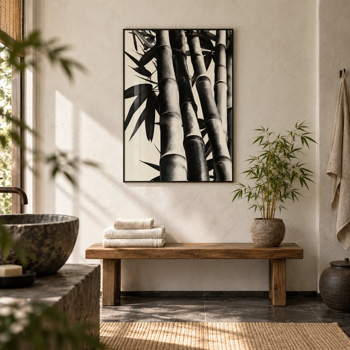 Bamboo Black And White Print, framed on the wall of a calm Japandi bathroom with a limewashed white wall and a dark stone floor