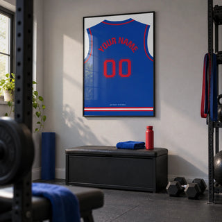 Basketball Jersey Poster in Blue with Red Number, framed on the wall of a small home gym in a converted UK garage with pale grey painted walls and plain dark rubber flooring