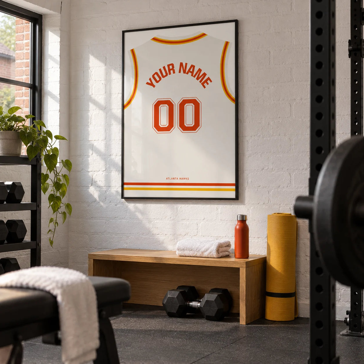 Basketball Jersey Poster in White with Red and Yellow Trim, framed on the wall of a compact garage-conversion home gym in a UK terraced house